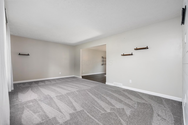1242 Springbrook Dr, Mansfield, OH 44906 - empty room featuring dark carpet and baseboards