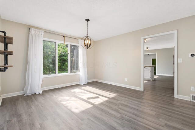 1242 Springbrook Dr, Mansfield, OH 44906 - empty room featuring wood finished floors and a chandelier