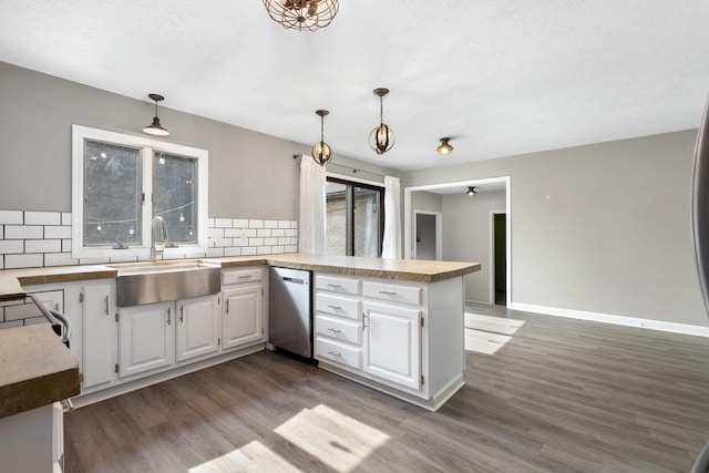 1242 Springbrook Dr, Mansfield, OH 44906 - kitchen with a peninsula, dark wood-type flooring, tasteful backsplash, white cabinetry, and stainless steel appliances