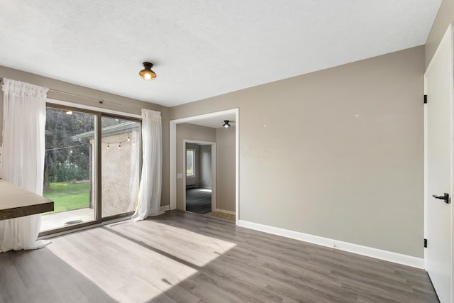 1242 Springbrook Dr, Mansfield, OH 44906 - unfurnished dining area with wood finished floors and a textured ceiling