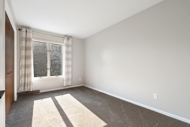 1242 Springbrook Dr, Mansfield, OH 44906 - empty room featuring dark colored carpet and baseboards