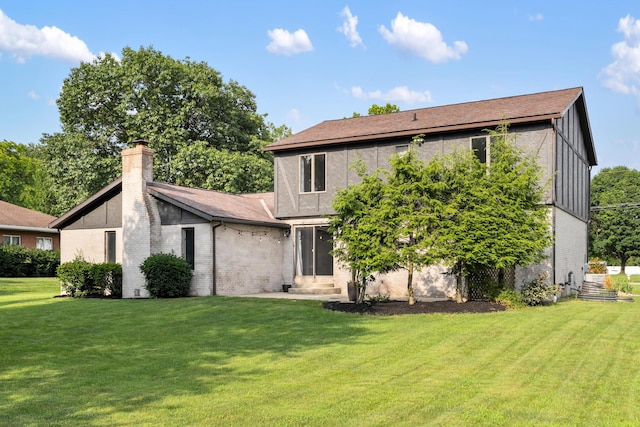1242 Springbrook Dr, Mansfield, OH 44906 - back of property with brick siding, a yard, a chimney, and board and batten siding