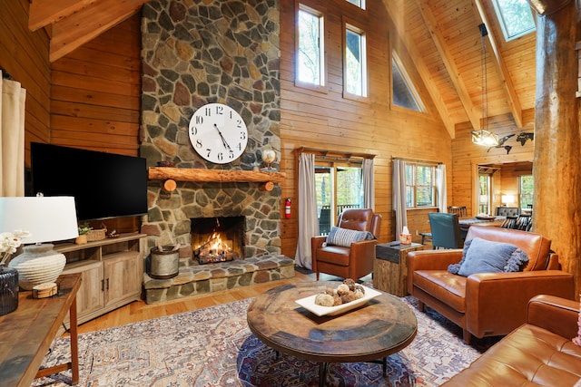 16651 Skinner Rd, Logan, OH 43138 - living area with wood finished floors, high vaulted ceiling, wooden walls, a wood ceiling with exposed beams, and a stone fireplace