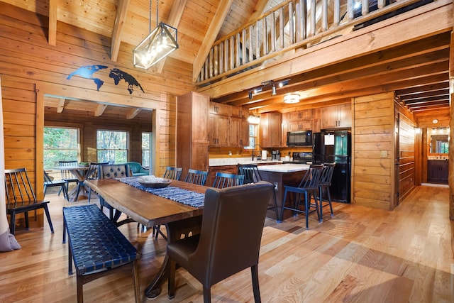 16651 Skinner Rd, Logan, OH 43138 - dining room with wooden walls, light wood-style floors, a wooden ceiling with exposed beams, and high vaulted ceiling