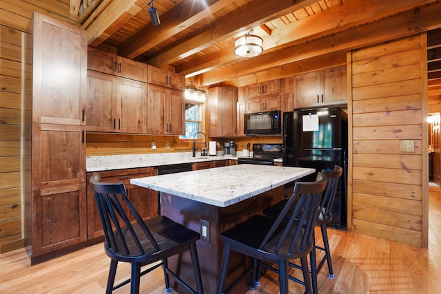 16651 Skinner Rd, Logan, OH 43138 - kitchen with black appliances, wooden walls, light wood finished floors, a wooden ceiling with exposed beams, and a kitchen breakfast bar