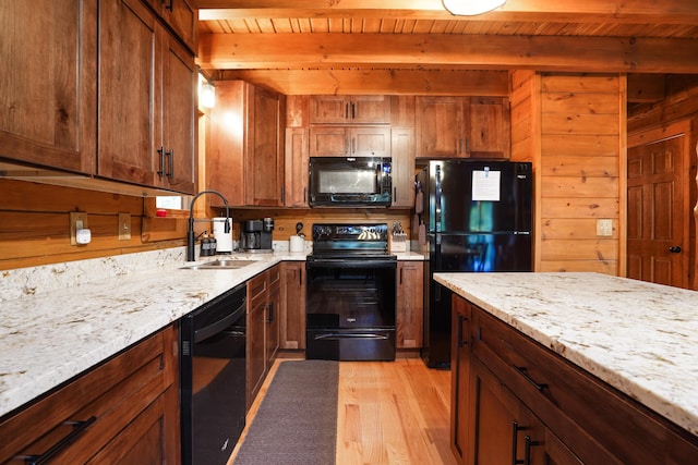 16651 Skinner Rd, Logan, OH 43138 - kitchen with black appliances, a wooden ceiling with exposed beams, light wood finished floors, and light stone countertops