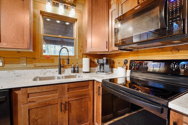 16651 Skinner Rd, Logan, OH 43138 - kitchen featuring black appliances, light stone countertops, and brown cabinetry