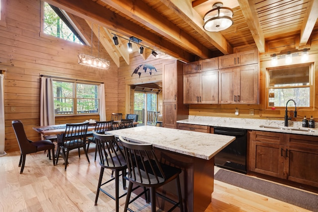 16651 Skinner Rd, Logan, OH 43138 - kitchen featuring dishwasher, light wood-type flooring, wood walls, wood ceiling, and a breakfast bar area