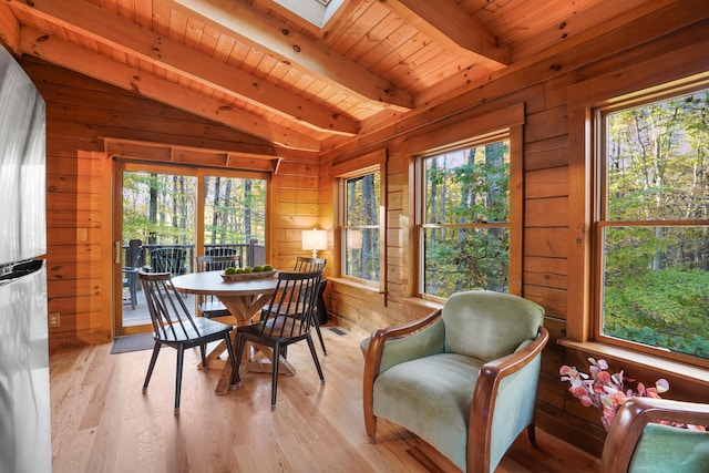 16651 Skinner Rd, Logan, OH 43138 - dining space featuring wooden walls, wood ceiling, light wood-type flooring, and a skylight