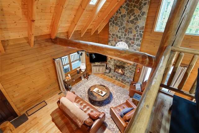 16651 Skinner Rd, Logan, OH 43138 - living room featuring wooden ceiling, wood-type flooring, wood walls, and a fireplace