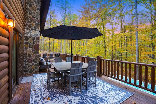 16651 Skinner Rd, Logan, OH 43138 - deck at dusk with outdoor dining space and a view of trees