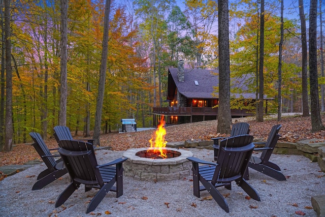 16651 Skinner Rd, Logan, OH 43138 - view of patio / terrace featuring a fire pit, a wooden deck, and a wooded view