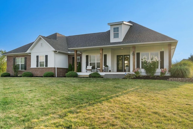 4881 Hoover Rd, Grove City, OH 43123 - view of front of home with board and batten siding, a front lawn, a shingled roof, and brick siding