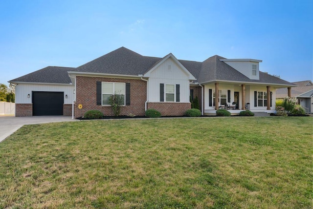 4881 Hoover Rd, Grove City, OH 43123 - view of front of house with board and batten siding, covered porch, an attached garage, brick siding, and driveway