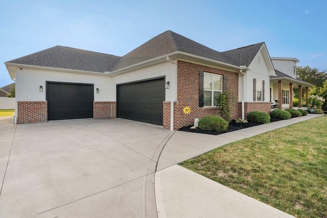 4881 Hoover Rd, Grove City, OH 43123 - view of property exterior with brick siding, a garage, concrete driveway, and a shingled roof