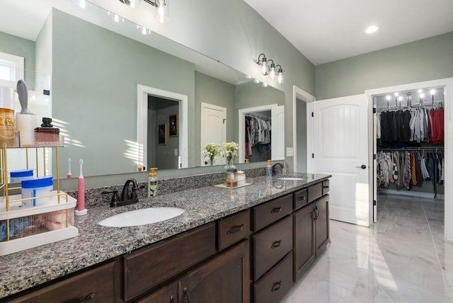 4881 Hoover Rd, Grove City, OH 43123 - bathroom featuring double vanity, a walk in closet, and marble finish flooring