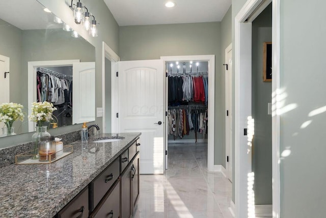 4881 Hoover Rd, Grove City, OH 43123 - bathroom with marble tiled floors, vanity, a spacious closet, and a chandelier