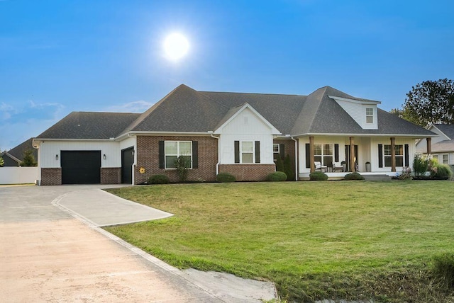 4881 Hoover Rd, Grove City, OH 43123 - view of front facade with driveway, a garage, a porch, brick siding, and a front yard