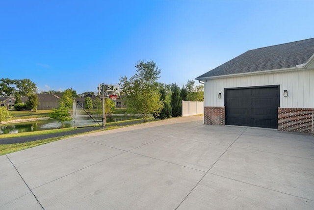 4881 Hoover Rd, Grove City, OH 43123 - view of property exterior featuring brick siding, driveway, board and batten siding, and a shingled roof