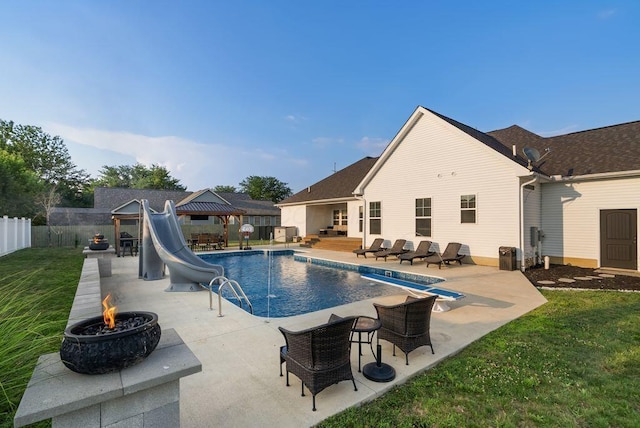 4881 Hoover Rd, Grove City, OH 43123 - view of pool with a gazebo, an outdoor fire pit, a water slide, a fenced backyard, and a patio