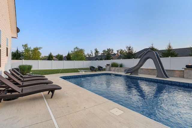 4881 Hoover Rd, Grove City, OH 43123 - view of swimming pool featuring a water slide, a patio area, and a fenced backyard