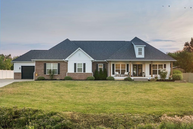 4881 Hoover Rd, Grove City, OH 43123 - view of front of home featuring a porch, an attached garage, driveway, brick siding, and roof with shingles