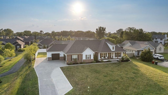 4881 Hoover Rd, Grove City, OH 43123 - view of front of home featuring driveway, an attached garage, a residential view, a front lawn, and covered porch