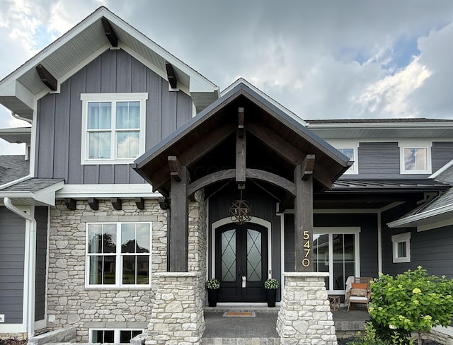 5470 Maple Glen Dr, Galena, OH 43021 - view of exterior entry with stone siding, board and batten siding, and a porch