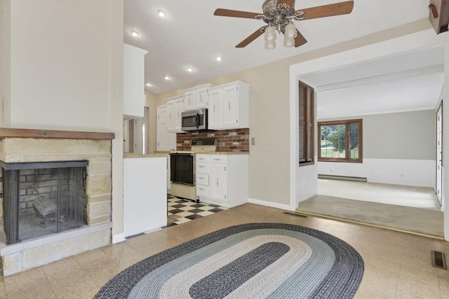 1725 Graham Dr NE, Lancaster, OH 43130 - kitchen featuring white electric stove, stainless steel microwave, a ceiling fan, light countertops, and white cabinetry