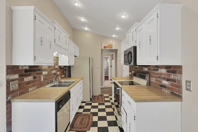 1725 Graham Dr NE, Lancaster, OH 43130 - kitchen with white appliances, tile patterned floors, decorative backsplash, white cabinets, and lofted ceiling