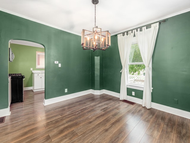 366 S Richardson Ave, Columbus, OH 43204 - empty room featuring ornamental molding, dark wood finished floors, arched walkways, and a chandelier