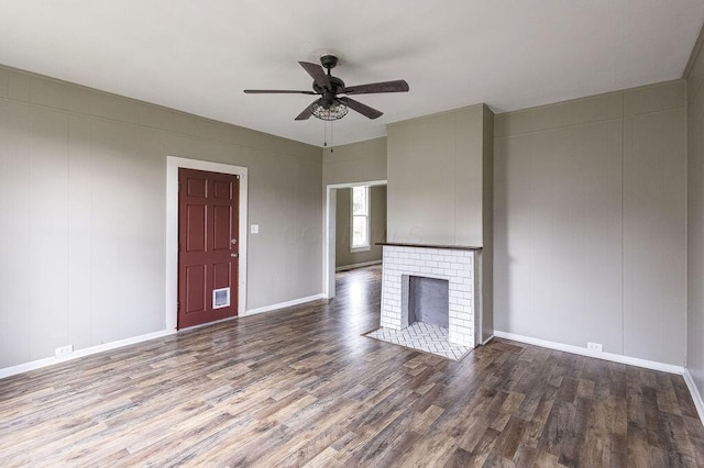 211 Buckingham St, Newark, OH 43055 - unfurnished living room featuring wood finished floors, a ceiling fan, and a fireplace