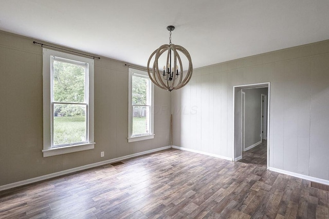 211 Buckingham St, Newark, OH 43055 - empty room with a chandelier, dark wood-style floors, and healthy amount of natural light