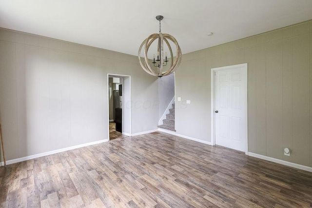 211 Buckingham St, Newark, OH 43055 - unfurnished room with a chandelier, stairs, and wood finished floors