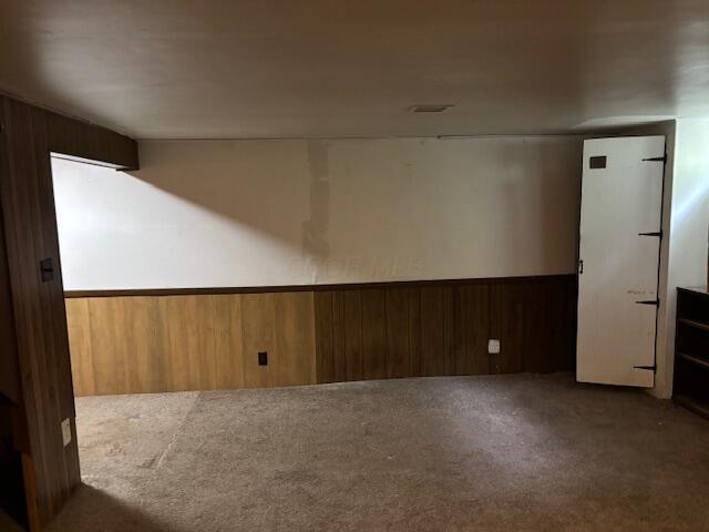 2382 Hardesty Dr S Unit Q5, Columbus, OH 43204 - spare room featuring carpet, wood walls, and wainscoting