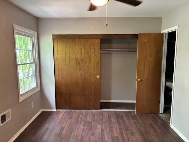 2382 Hardesty Dr S Unit Q5, Columbus, OH 43204 - unfurnished bedroom with wood finished floors, a closet, multiple windows, and a ceiling fan