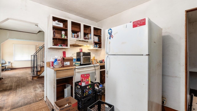 1822 W Mound St, Columbus, OH 43223 - kitchen featuring freestanding refrigerator, wood finished floors, open shelves, and a textured ceiling