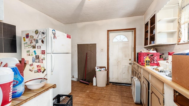 1822 W Mound St, Columbus, OH 43223 - kitchen with freestanding refrigerator, a textured ceiling, light countertops, and open shelves