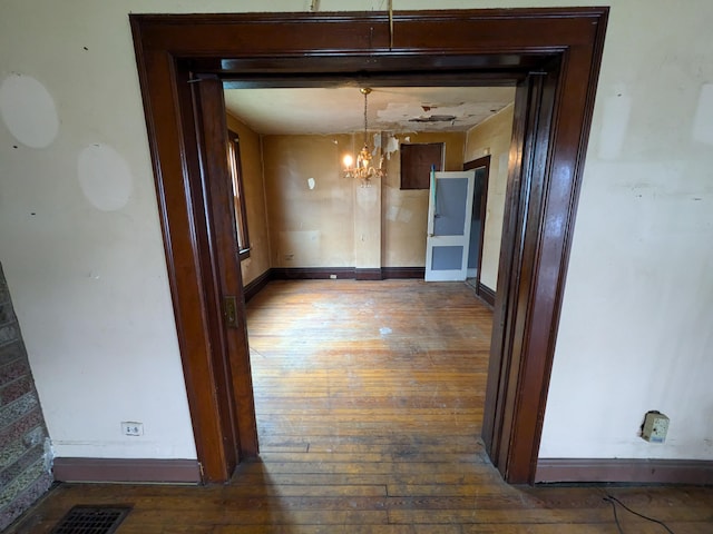 1325 Smith Rd, Columbus, OH 43207 - unfurnished dining area featuring hardwood / wood-style floors and a chandelier