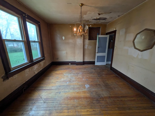 1325 Smith Rd, Columbus, OH 43207 - unfurnished dining area with hardwood / wood-style floors, a chandelier, and healthy amount of natural light