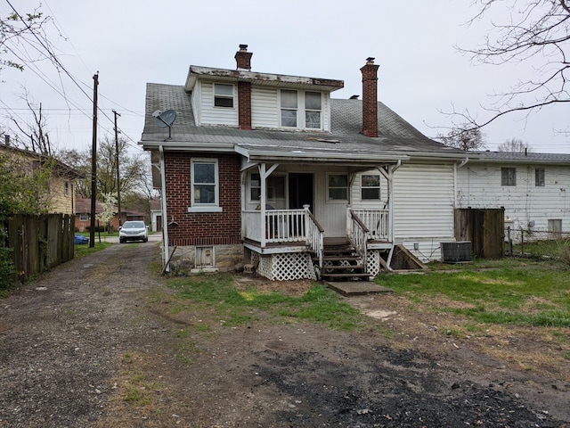 1325 Smith Rd, Columbus, OH 43207 - rear view of property with a chimney, covered porch, brick siding, and dirt driveway