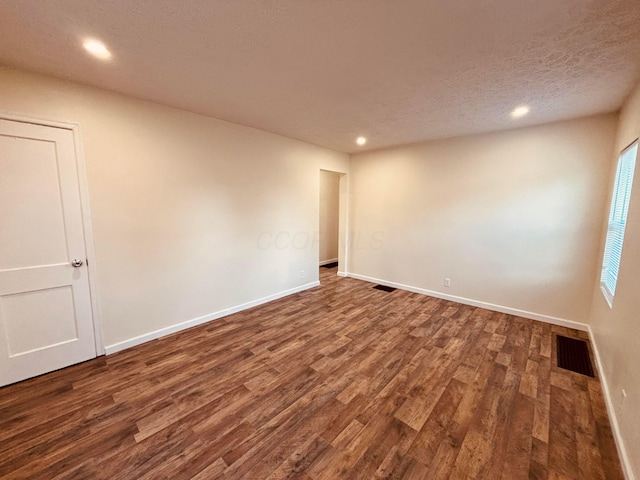 3067 E 13th Ave, Columbus, OH 43219 - empty room featuring dark wood-style floors, recessed lighting, and a textured ceiling