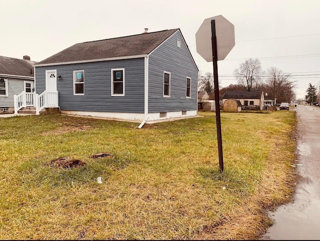 3067 E 13th Ave, Columbus, OH 43219 - view of side of home featuring a lawn and roof with shingles