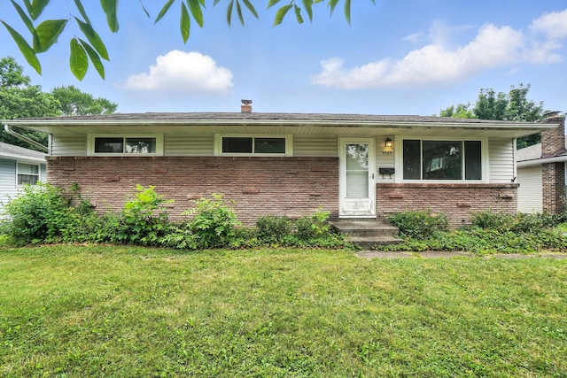 3563 Astor Ave, Columbus, OH 43227 - view of front facade featuring brick siding, a front lawn, and a chimney