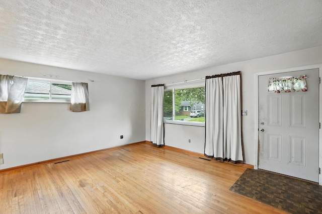 3563 Astor Ave, Columbus, OH 43227 - foyer entrance with hardwood / wood-style flooring and a textured ceiling
