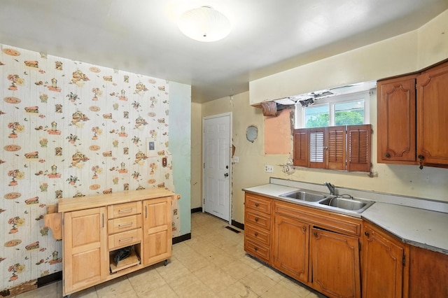 3563 Astor Ave, Columbus, OH 43227 - kitchen with light countertops, light flooring, wallpapered walls, and brown cabinets