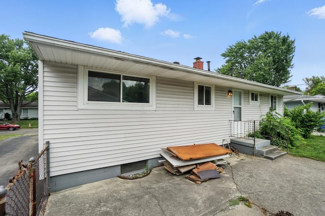 3563 Astor Ave, Columbus, OH 43227 - back of house with a chimney and a patio area