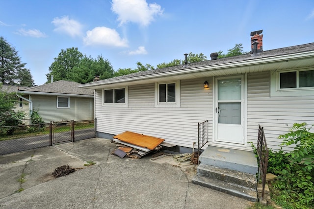 3563 Astor Ave, Columbus, OH 43227 - rear view of house featuring a gate, a chimney, and a patio