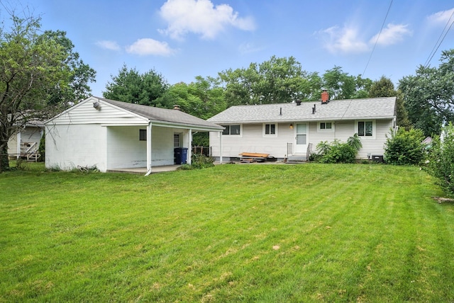 3563 Astor Ave, Columbus, OH 43227 - rear view of house with a lawn, a chimney, and entry steps