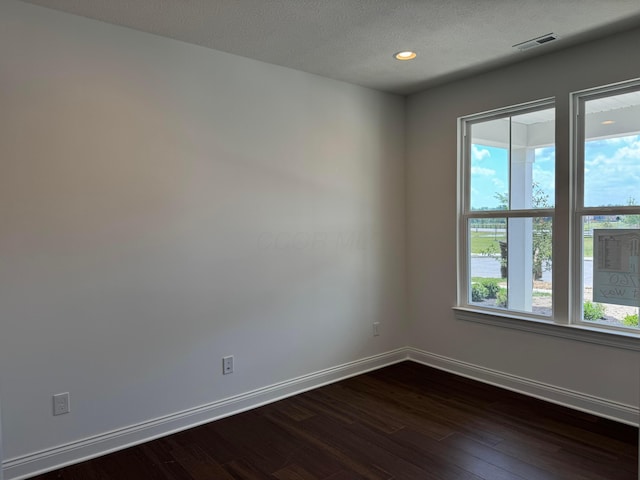8760 Apricot Way Lot 1917, Plain City, OH 43064 - empty room featuring dark wood finished floors, recessed lighting, and a textured ceiling